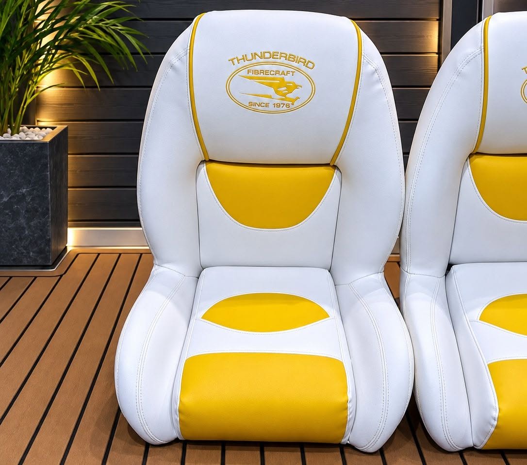 White and yellow Thunderbird Fibrecraft boat seats with an embroidered logo